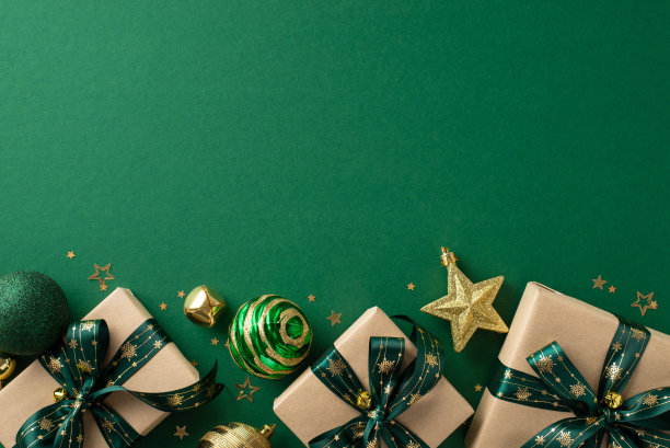 隆重的新年气氛。顶部图片展示手工礼盒，豪华饰品，闪闪发光的星星玩具，叮当作响的铃铛，金色的五彩纸屑铺在绿色的背景上，广告文字的空间图片下载