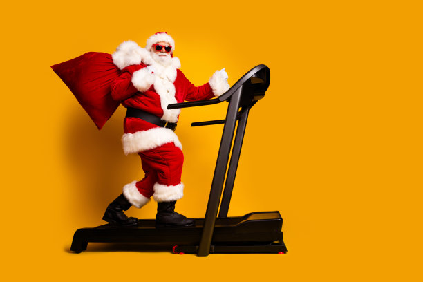 欢快的疯子圣诞老人手持给孩子们的礼物的全长照片空白的空间孤立的黄色背景图片下载