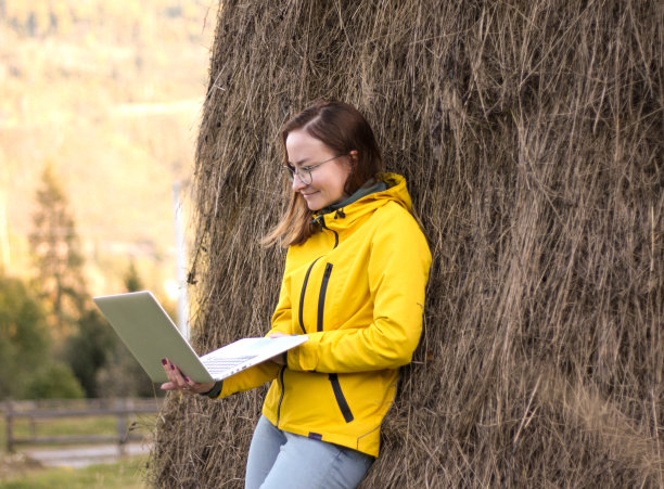 大自然中的女孩在笔记本电脑前工作图片下载