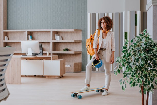 优雅的女商人穿着休闲装骑着滑板图片下载