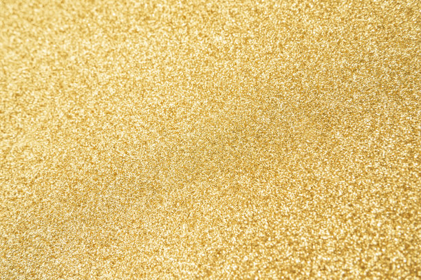 金色闪闪发光的纹理背景与亮片和火花图片下载