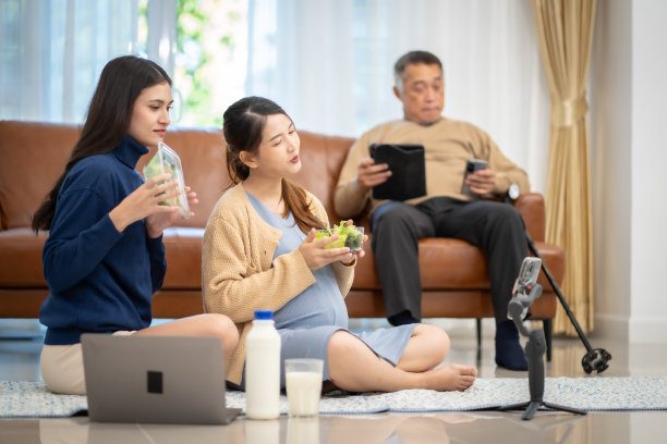 亚洲孕妇在家通过社交媒体吃蔬菜沙拉奶让其他妈妈看着图片下载
