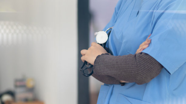 穿制服的女医生拿着听诊器等着给病人检查。图为，一名女医生手持听诊器，准备在医院治疗病人。用于插入医学文本的复制空间图片下载