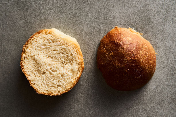 灰色混凝土背景上的汉堡面包或迷你面包。非常柔软的新鲜出炉的自制，涂了黄油。简约的照片。前视图。图片下载