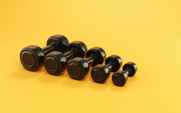 黑色塑料哑铃坐在柔软的黄色背景图片下载