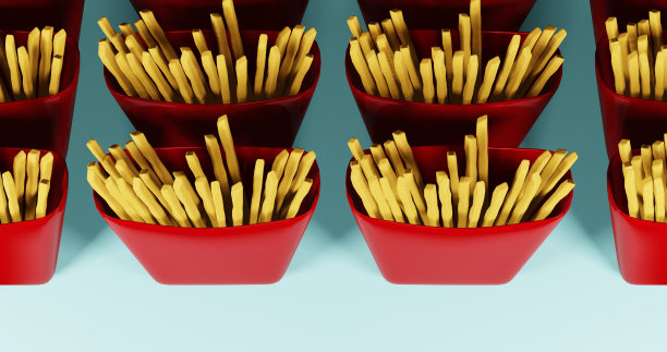 红色包装盒里的炸薯条。快餐，垃圾食品。图片下载