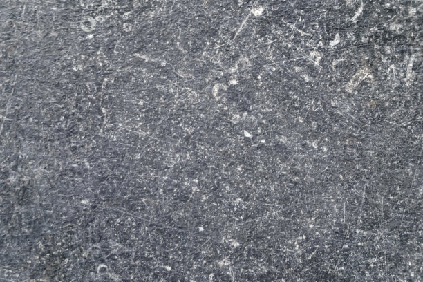 纹理的灰色石材表面为背景，近距离库存照片图片下载