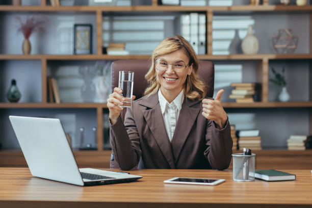 自信的资深女商人在办公室用笔记本电脑竖起大拇指图片下载