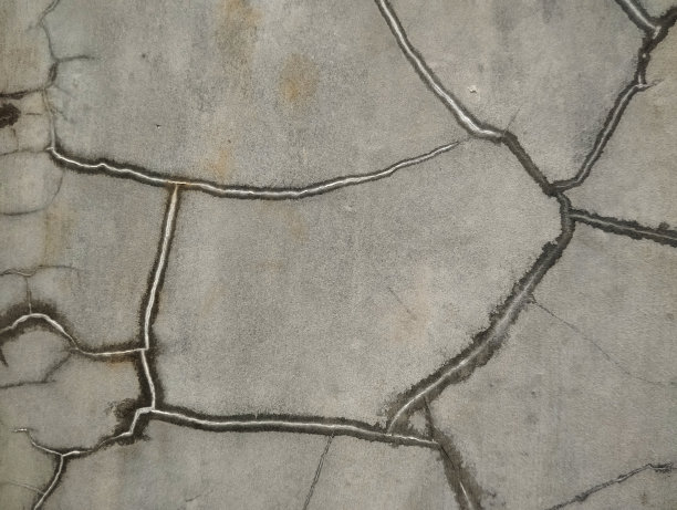 灰色墙壁裂缝纹理的照片很好作为背景图片下载