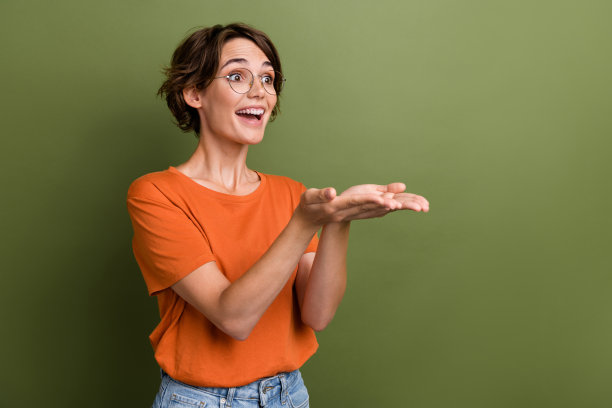 侧面照片的年轻惊讶时髦的女孩牵着两只手工人要求工资看起来空白空间孤立的卡其色背景图片下载