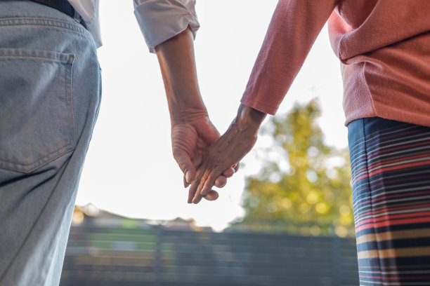 一对成熟的夫妇手牵着手走向阳台图片下载
