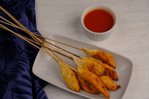 Sempolan是一种油炸食品，由鸡肉、鱼或虾混合木薯粉和香料制成。装在木桌上的白色盘子里。印尼的食物。图片下载