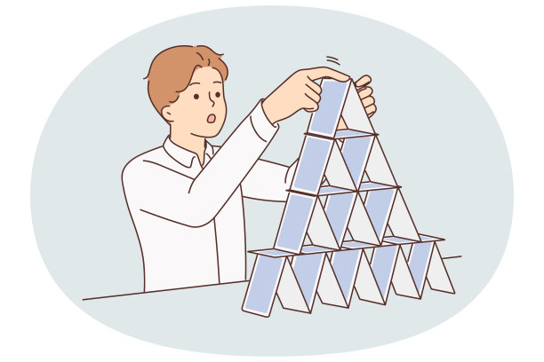 精力集中的人制作纸牌金字塔，象征着脆弱的商业结构图片下载