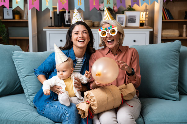 孙女宝宝和她的妈妈在家里为他们的祖母庆祝生日，并准备了一份大生日礼物作为惊喜。图片下载