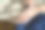 在这张剪短的图片中，一位中年亚洲女性正在用润肤霜涂抹双手干燥的皮肤，阳光温柔地照在她的皮肤上，突显出滋养的姿态。图片下载