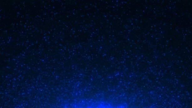 闪亮的蓝色颗粒在黑暗的背景上散落着闪闪发光的五彩纸屑图片下载