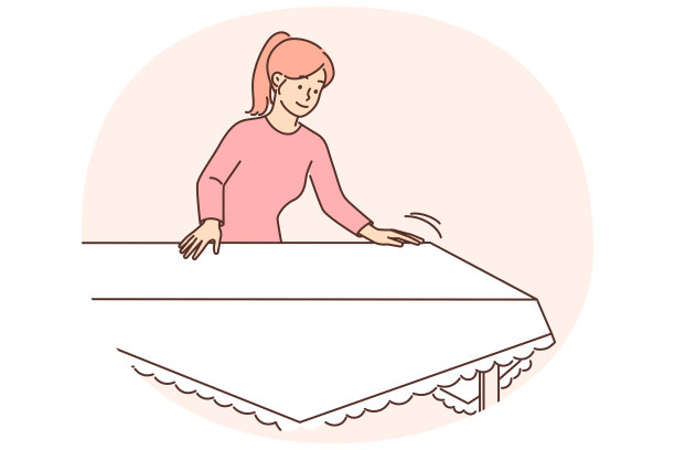 一位家庭主妇用白色桌布摆好餐桌，准备与家人共进节日晚餐或午餐图片下载