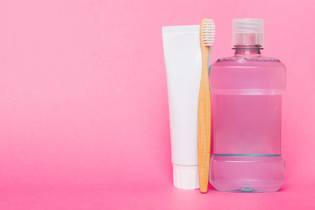 漱口水和其他口腔卫生产品在彩色桌面视图与复制空间。平的。口腔卫生。口腔护理产品和空间的文字在浅色背景。概念图片下载