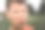 一个穿着橙色t恤的有趣男孩在日落时分在户外操场上玩耍的照片。图片下载