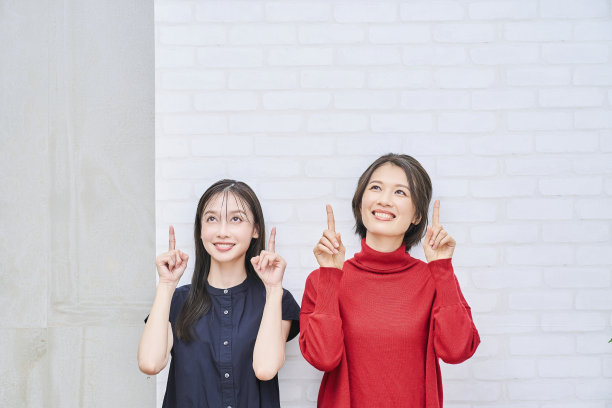 两个女人在室内指着上面图片下载