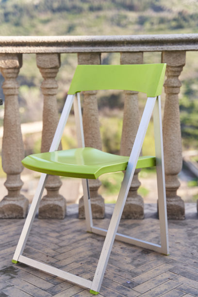 带栏杆的露台上的绿色折叠椅图片下载