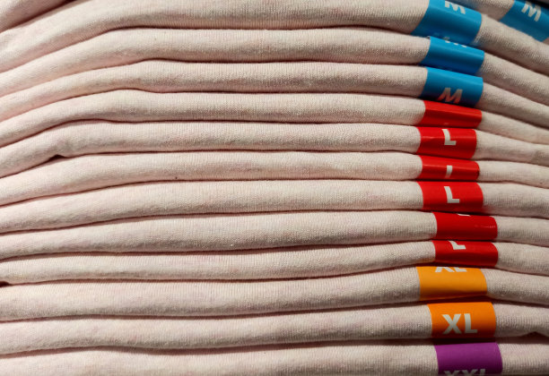 不同尺码的棉衣堆放在服装店里图片下载