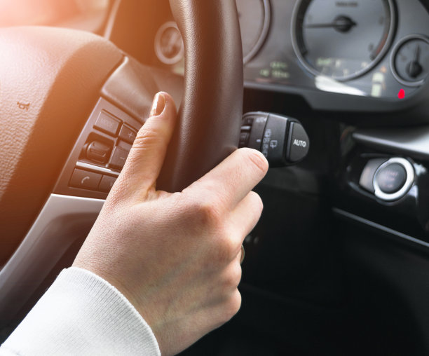 女人的手握着方向盘在开车。双手握着方向盘。现代汽车内部细节。图片下载