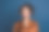 照片中可爱漂亮的女人穿着棕色丝绸衬衫，戴着眼镜，微笑着孤立的蓝色背景图片下载