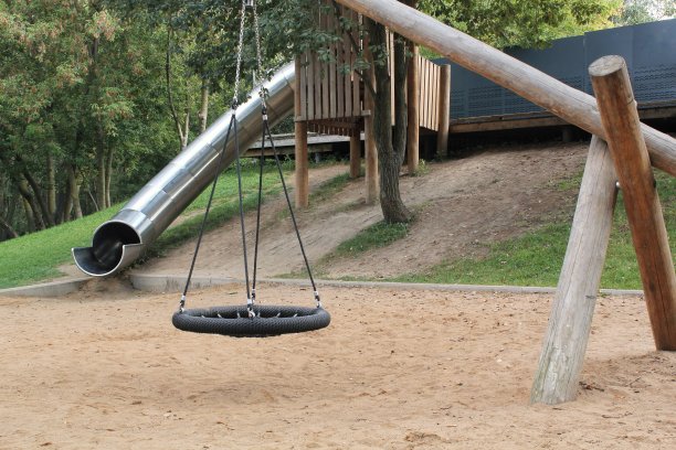 城市公共公园内采用天然环保材料制作的木制游乐场。现代安全儿童户外装备。可持续的生活方式和生态理念。孩子们在露天休息和做游戏图片下载