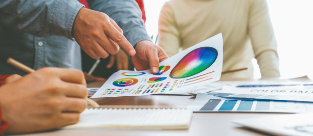 设计师团队讨论从色轮中选择颜色。斑叶。图片下载