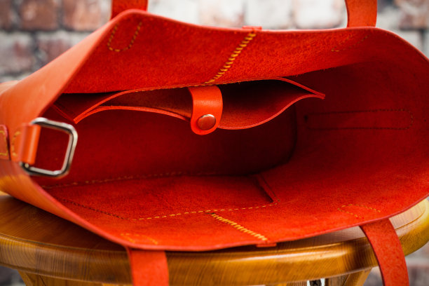 木质地板上的女性红色皮包，社交网络上某电子商务商店目录照片图片下载