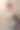 一位漂亮的年轻女子穿着闪亮的白色连衣裙，戴着手套，坐在一把黑色的椅子上。一位身材修长的黑发女子化了妆，高高的发型，戴着珠宝，手里拿着一朵红色的海葵。图片下载