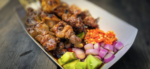 烤沙爹羊肉配烧烤调味汁和腌洋葱、辣椒和黄瓜，选择性对焦照片图片下载