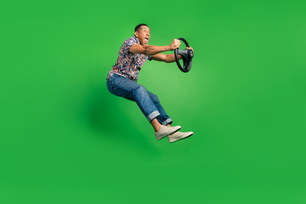 侧面照片的疯狂积极的人驾驶新的自己的汽车车辆看道路孤立的绿色背景图片下载