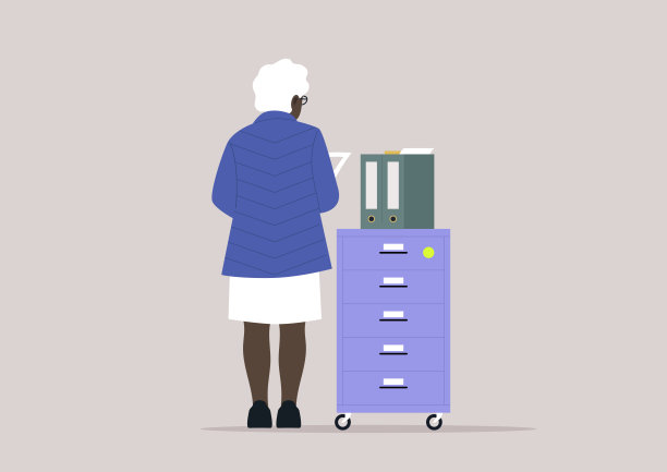 在现代办公环境中整理文件一个人站在文件柜旁，整理工作中的文件图片下载