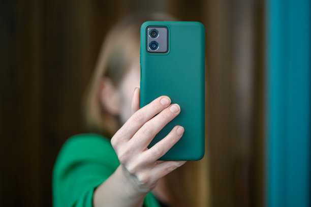 这个女孩手里拿着一部手机，用智能手机的前置摄像头给自己拍了一张照片图片下载