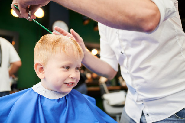 可爱男孩剪时髦发型的侧视图。图片下载