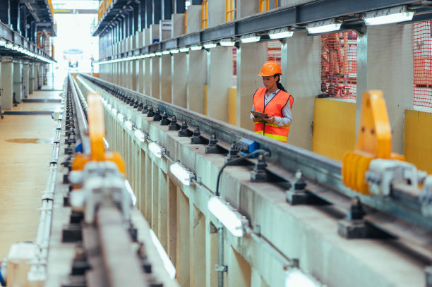 在这张引人注目的库存照片中，一名工程师在火车和铁路车库的动态环境中，沉浸在细致的维护任务中图片下载