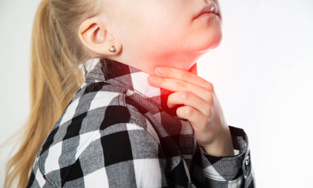 一个金发的白人女孩用手捂着她疼痛的红喉咙。儿童喉咙疼痛和发炎。扁桃体和淋巴结发炎，哮喘图片下载