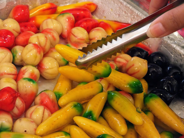 一个人切一碗五颜六色的蔬菜的照片。图片下载