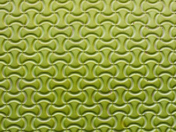 一张带有圆形图案的绿色瓷砖的照片。图片下载