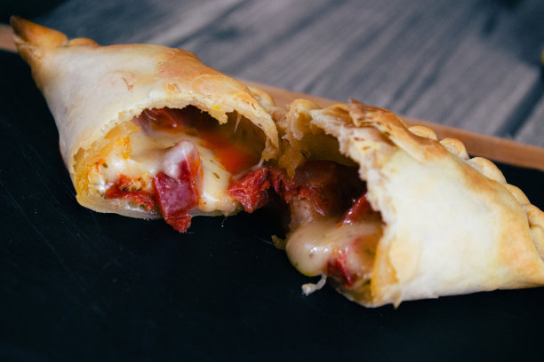 美味，开胃的西班牙辣香肠和奶酪肉馅卷饼，阿根廷美味佳肴，融化的奶酪图片下载