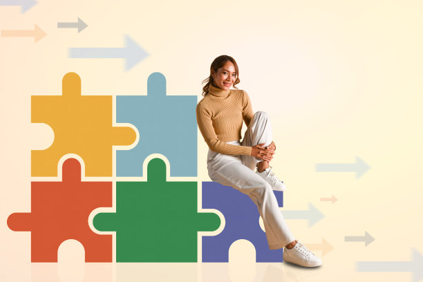 漂亮的年轻女子坐在彩色拼图片旁边，背景明亮，有复制空间图片下载