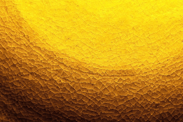 金色的背景纹理与砂岩圆像一个古老的太阳雕塑。图片下载