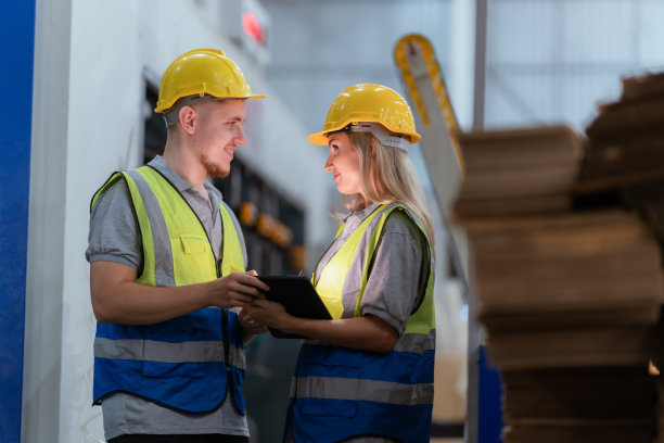 纸板箱制造工厂概念，工业工人使用机器在仓库储存或工厂生产中回收材料包装盒，用于全球物流业务图片下载