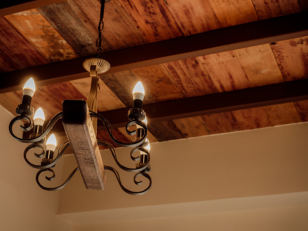 复古的木质枝形吊灯在客厅与复制空间，经典风格的复古灯或蜡烛灯泡挂在木制天花板，室内，室内阁楼风格的建筑。复古的灯光装饰。图片下载