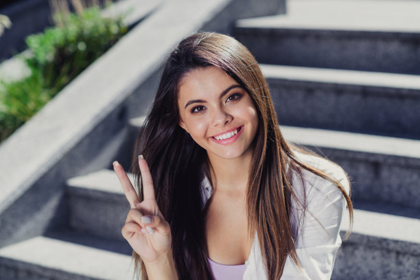 开朗、积极、快乐、好心情的女孩走在市中心的照片，显示出春天的阳光明媚的天气图片下载