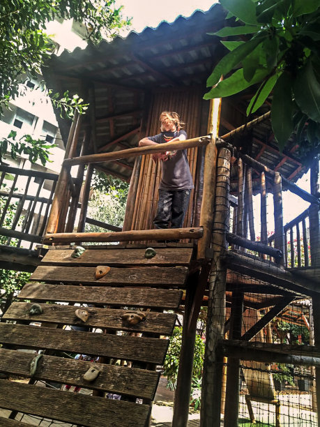 男孩在玩具屋的窗口玩耍-早上的例行公事图片下载