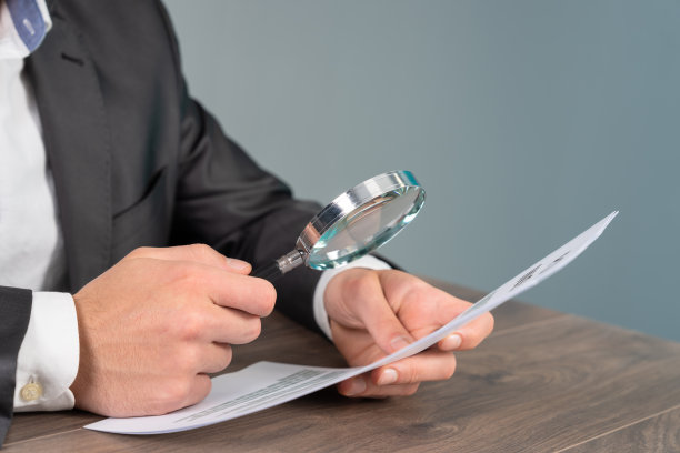 一个男人用放大镜检查文件图片下载