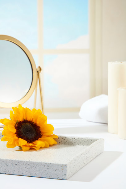 向日葵和浴室的主题，一个空的大理石托盘装饰的向日葵，书桌铜镜，蜡烛和浴巾，在窗户的背景。正面，广告照片图片下载